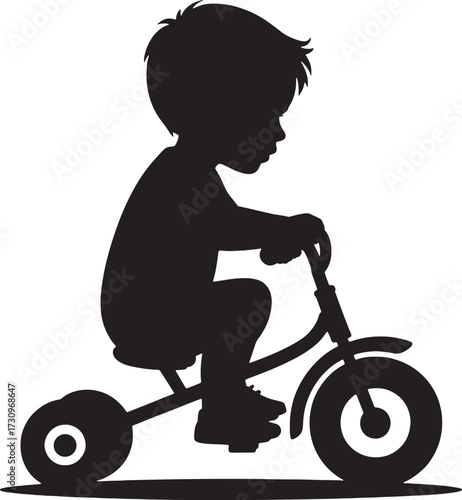 Black silhouette of a young boy riding a tricycle child