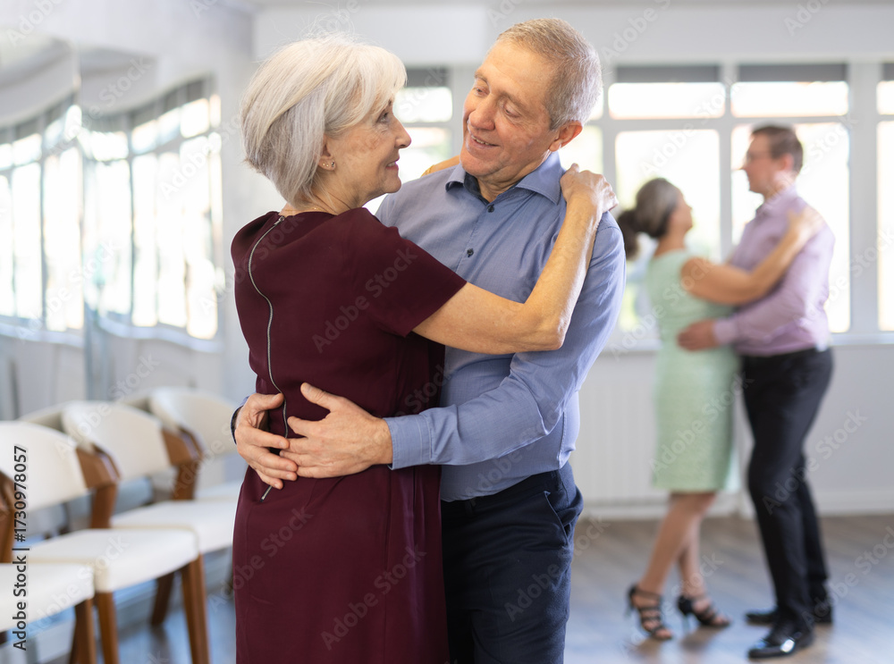 Fototapeta premium Elderly man and elderly woman dance ballroom dance waltz in studio