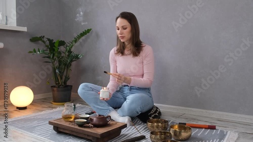 Woman lighting incense for meditation and spiritual practice