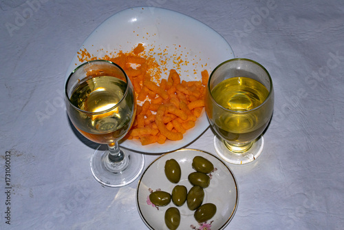White wine and olives on the table