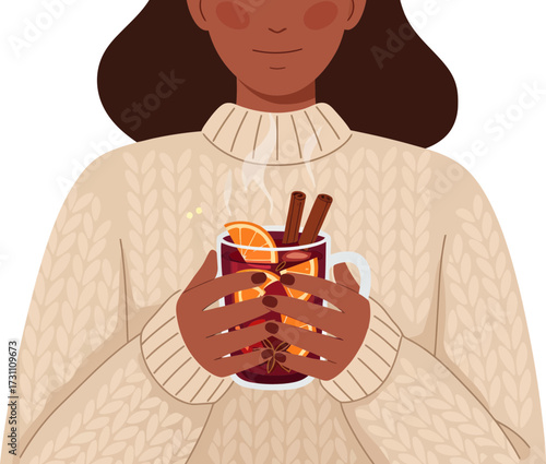 Cozy winter scene with a person holding a warm mulled wine beverage in a festive setting