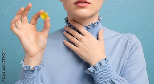 sore throat Woman holding lozenge to soothe sore throat