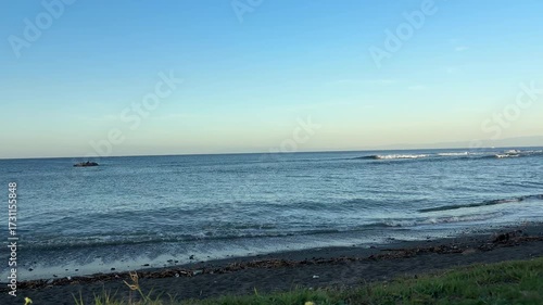 真夏の青い空と沖で白い波がきれいに割れているビーチ