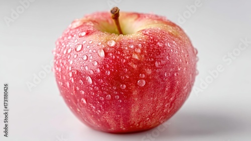 Close Up Of A Ripe Red Apple With Water Droplets Against White Background
