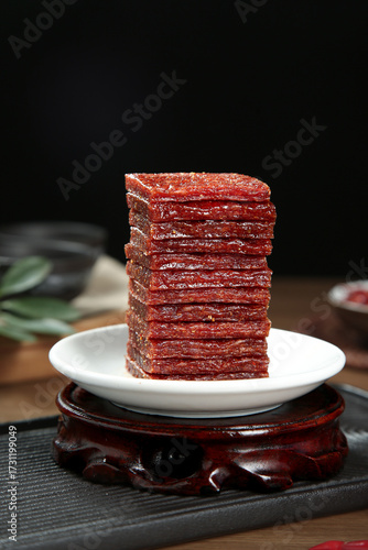 Spicy Red Chili Meat Jerky Sticks Stack on White Plate - Traditional Dried Snack Food