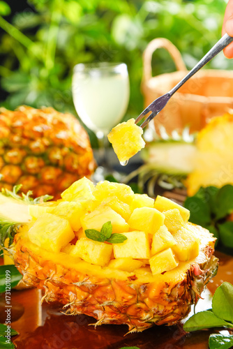 Fotografie Fresh Pineapple Chunks Served in Natural Pineapple Bowl with Fork - Tropical Fru