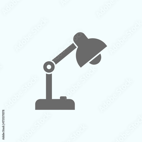 Gray desk lamp icon on a light blue background.