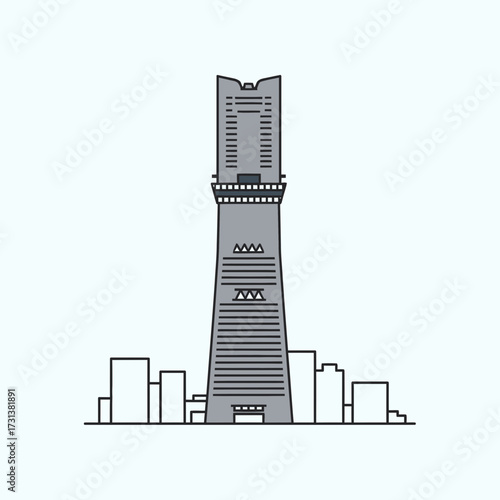 Tall modern skyscraper against a light background with smaller buildings.