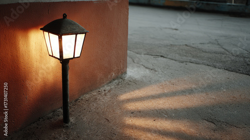 Vintage streetlamp casting a warm glow on a quiet urban street.