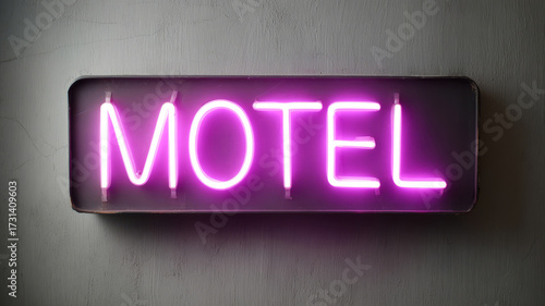 Bright pink neon sign with the word 'Motel' on a gray wall.