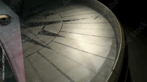 Closeup on a compass pointing direction. Old compass. Macro shot, shallow focus. Travel, geography, navigation, tourism and exploration concept background. Closeup of compass navigation tool.