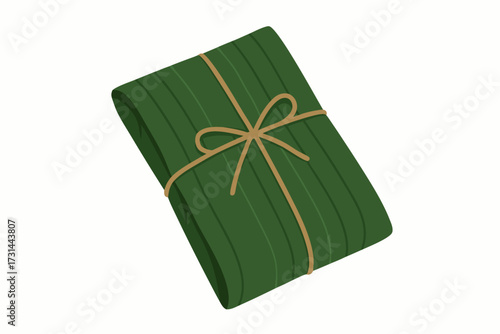 A Green Tamale Wrapped in Banana Leaves and Tied with Twine