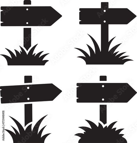 Four wooden directional signposts silhouette