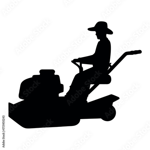 Silhouette of a person riding a lawnmower in a field