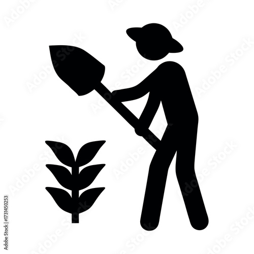 Silhouette of a farmer digging near a plant with a shovel