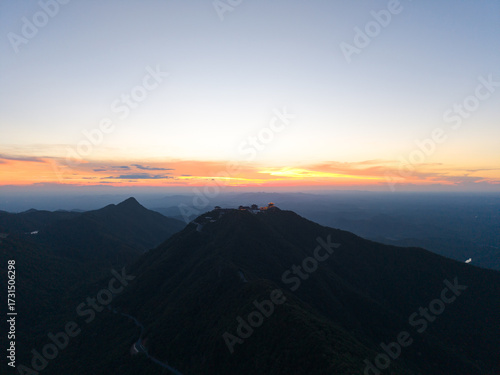 Dahong Mountain at dawn with peaks silhouetted against the colorful sky, offering a serene view of Suizhou, China's landscape.