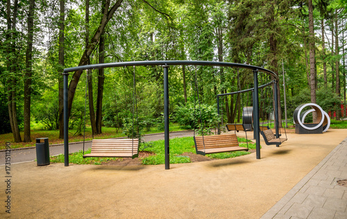Photography Modern Park Recreational Area with Wooden Swings in a Scenic Green Forest Settin