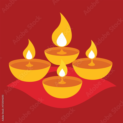 four golden diyas placed on colorful silk fabric  (1).eps