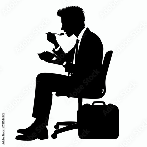 Businessman eating lunch while sitting in office chair  