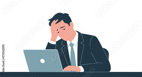 Frustrated businessman with head in hand working on a laptop expressing work fatigue and stress