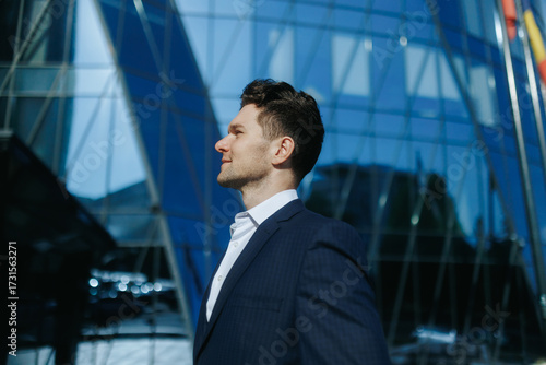 Side Portrait of Stylish Man in Suit Smiling in the City