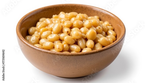 Cooked yellow soybeans in a ceramic bowl on white background  