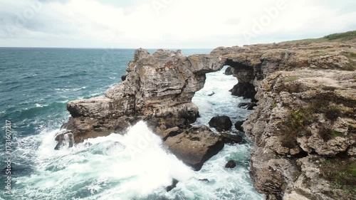 Stormy weather in rock arch in Tyulenovo, Bulgaria. Tulenovo stone arc. Dramatic landscape symbolizing nature's power and wild beauty.