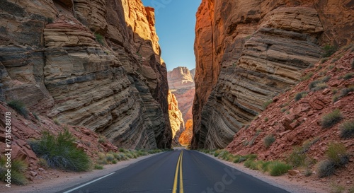 Scenic road through canyons featuring layered rock formations under bright sunlight perfect for travel destinations