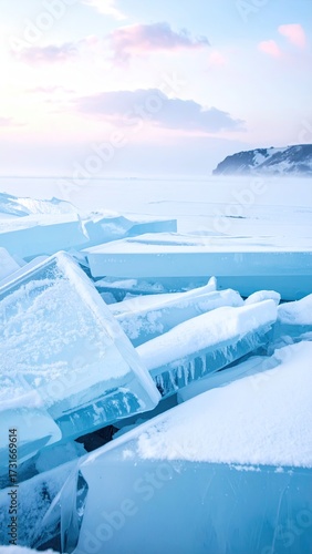 Frozen Ice Formations Stacked on a Shoreline with Snow and Overcast Sky with Island Background in Pale Blues and Whites Winter Landscape