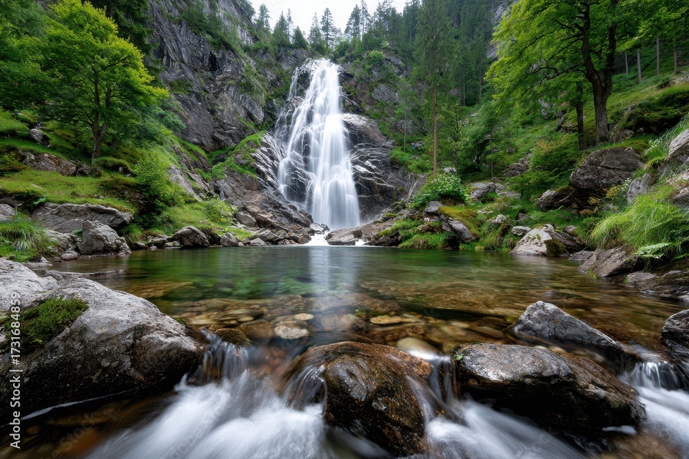 Fototapeta premium Stunning Waterfall Cascades into a Crystal Clear Pool