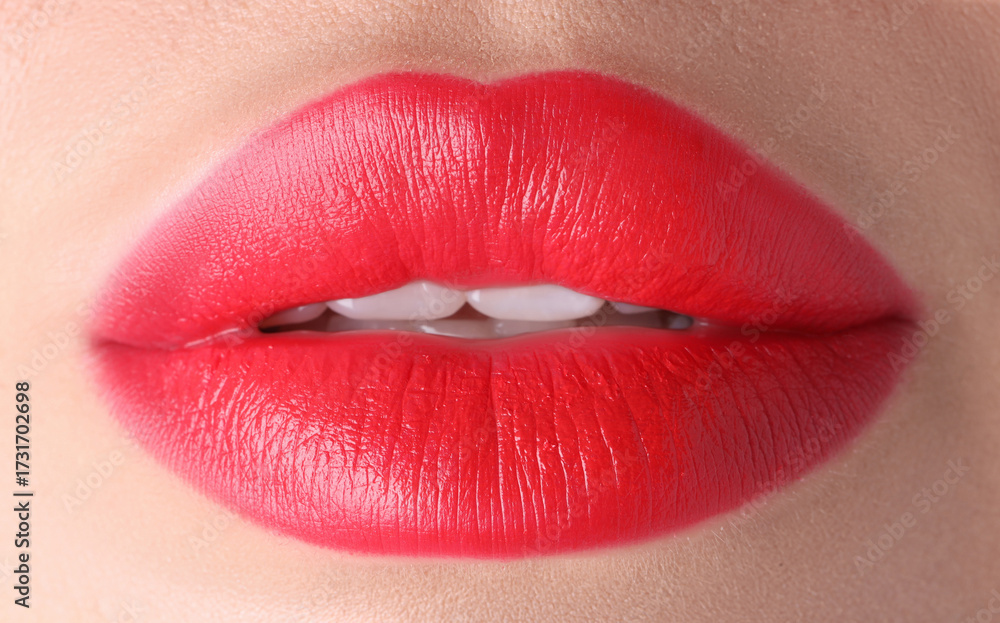 Obraz premium Woman with beautiful red lipstick on her lips, macro view