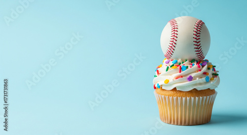 A baseball placed on top of a frosted cupcake with colorful sprinkles, positioned neatly to the right side of a pastel blue background. The left half remains uncluttered for text. Bright studio lighti