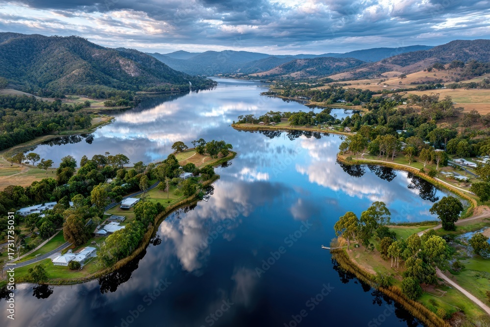 Fototapeta premium Aerial view of a serene lakeside village at sunset
