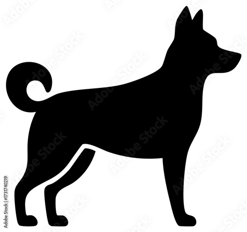 Black silhouette of a dog with curled tail and pointed ears standing profile