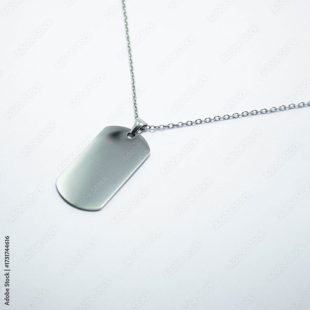 Fototapeta premium Silver pendant on a chain isolated on a white background. Concept of jewelry catalog photography, fashion accessory, minimal design, and elegant gift ideas