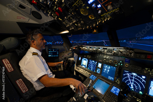 Airline pilot training on a flight simulator at night