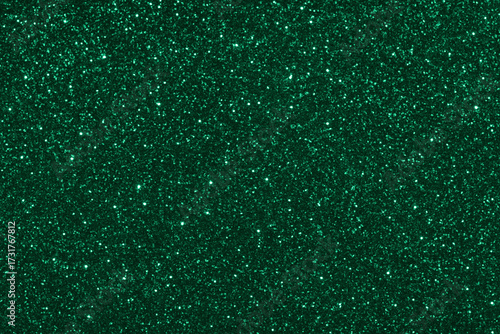Emerald green glitter background with shimmering effect.