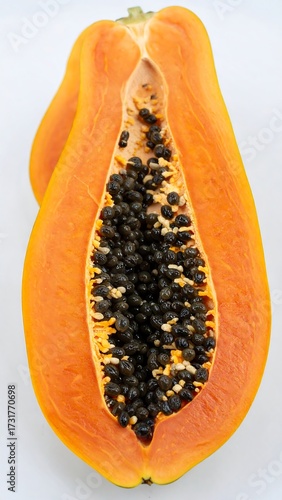 Close-up of a papaya, cut in half, showing seeds