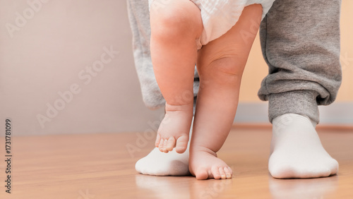 Quadro em tela The baby takes his first steps with his dad