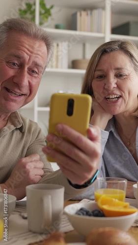 Senior couple making a video call during breakfast