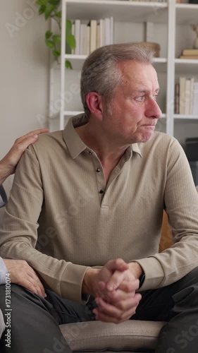 Stressed senior man receiving comfort and support from his wife