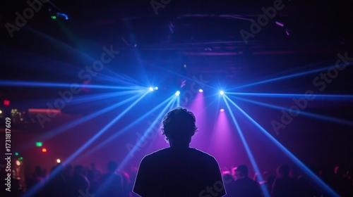 Excited music fans dancing at a vibrant nightclub with dynamic lights and energetic atmosphere