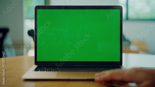 Isolated Green Screen Mock Up Laptop with opened screen on the desk indoor