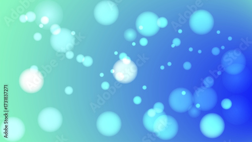 Dreamy abstract background with soft blue and green bokeh lights creates calming and ethereal atmosphere. blurred circles of light add sense of depth and tranquility