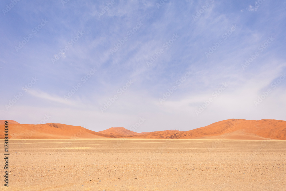 Fototapeta premium Sossusvlei in Namibia is a desert wonder, famous for its giant red dunes, glowing at sunrise and sunset