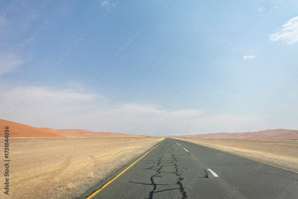 Fototapeta premium Inside Sossusvlei, gravel roads wind through red dunes to Deadvlei, Big Daddy, and Sesriem Canyon, Namibia