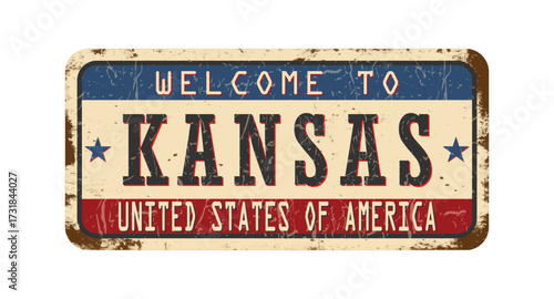 Welcome to Kansas. An old worn sign with an inscription. Welcome metal plaque with rust elements