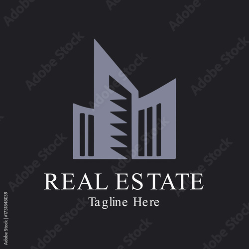 Illustration of modern real estate logo featuring a stylized building silhouette in grey with text reales tate tagline here on a dark background