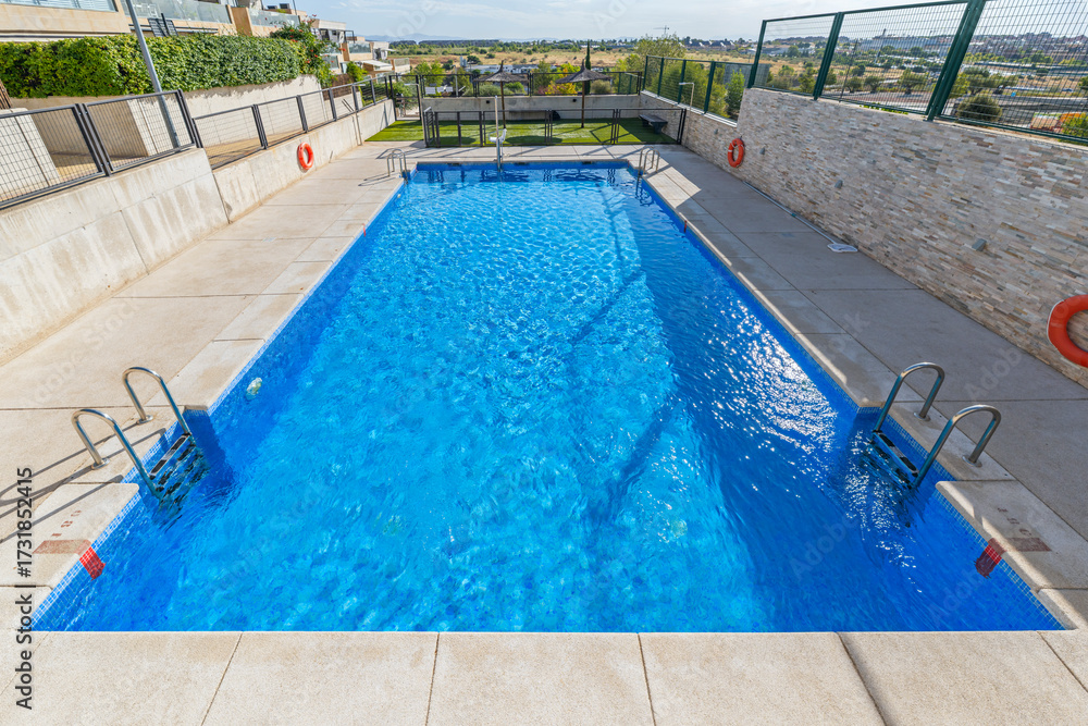 Obraz premium Pool complex with towel service, premium sun loungers, and designer umbrellas