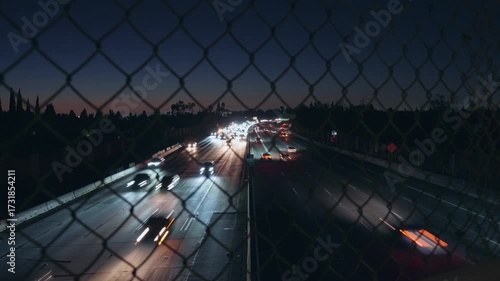 Wide shot of freeway traffic at night in Los Angeles, captured with motion blur for a dynamic, cinematic look. Perfect for urban, transportation, and city-life projects.
